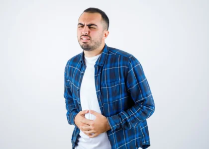 young man having bellyache checked shirt white t shirt looking exhausted 50 scaled 1 - Laparoscopic Surgeon Dr. Digant Pathak